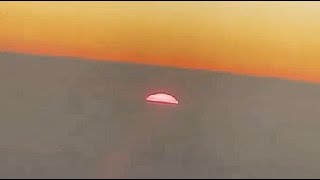 The Sun Appears To Set Between The Clouds, Filmed During A Flight From Queensland To Japan