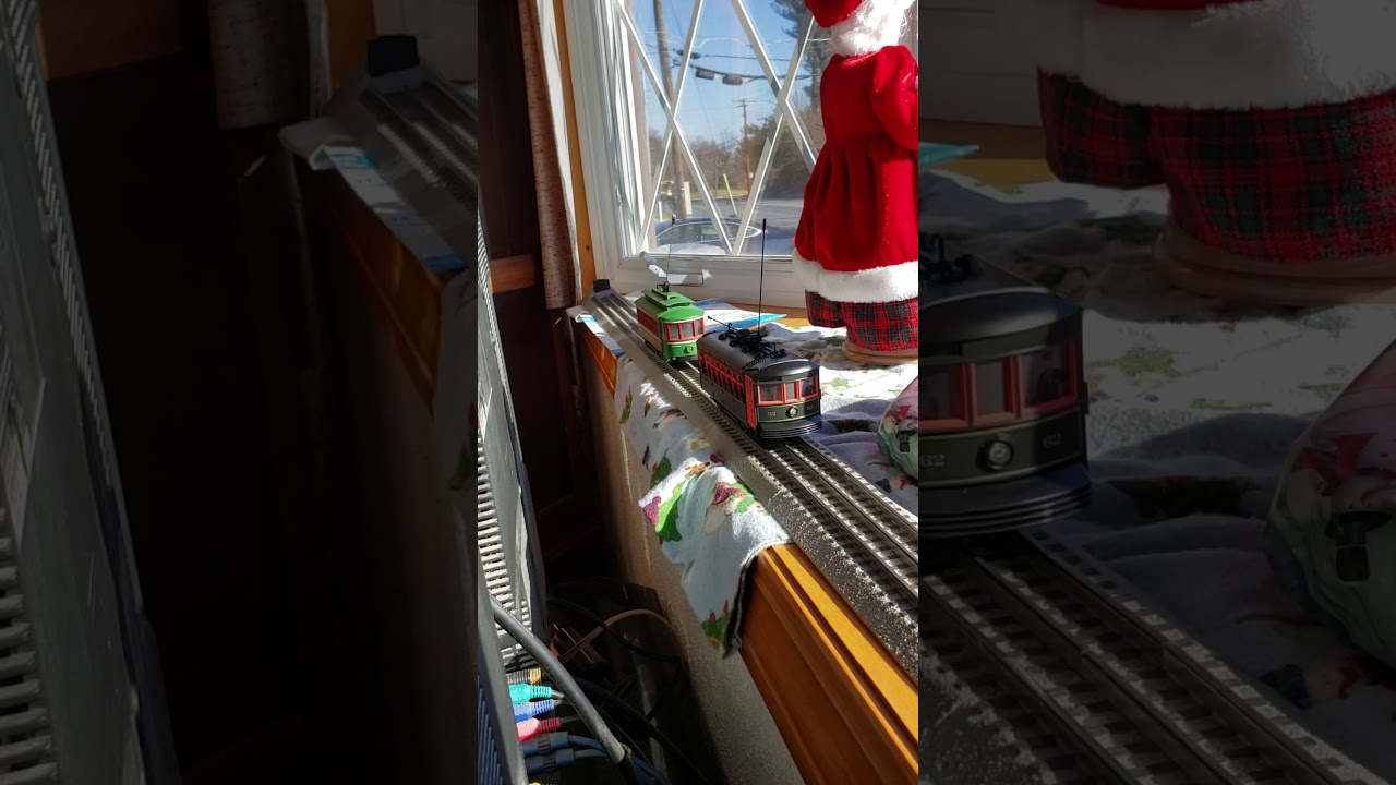 Mth Christmas trolley and lionel trolley running together