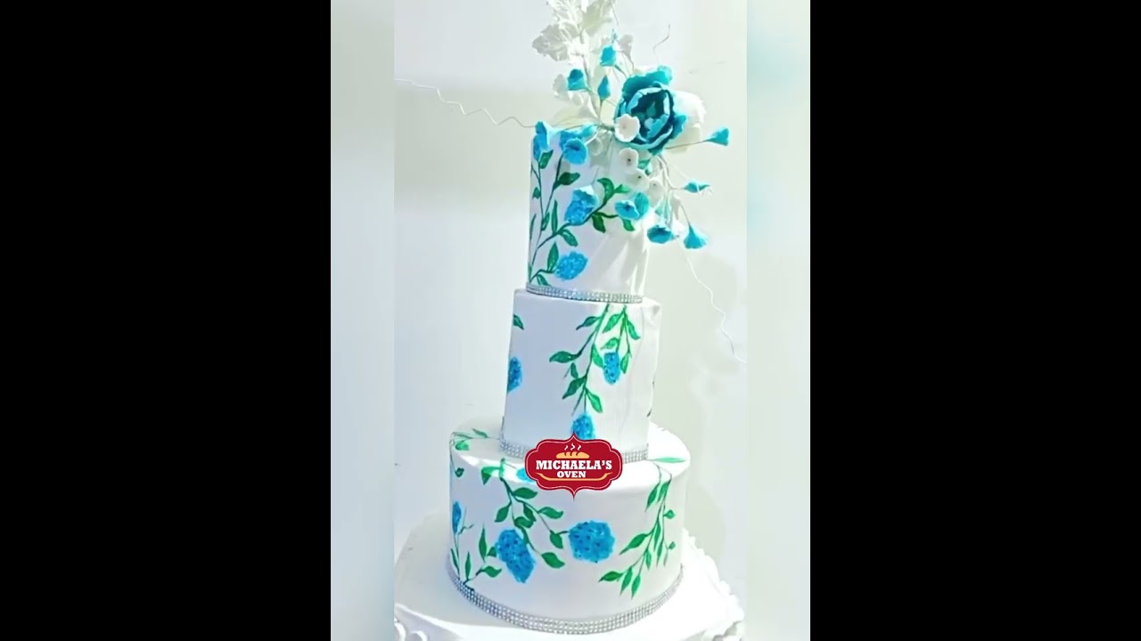 An ethereal wedding cake in soft, turquoise blue floral notes from Michaela’s Oven
