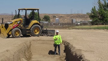 Digging A Trench With A  CAT Skip Loader  By Operator Elliston