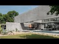 A Concrete Home With Beautiful View Of Pool And Garden