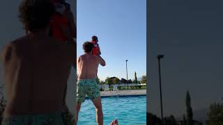 Guy throws boy in pool and he belly flops
