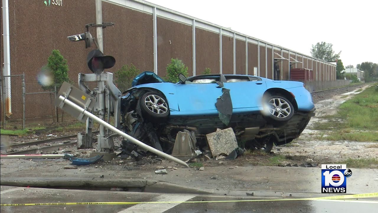 Driver hospitalized after crashing into railroad crossing - YouTube
