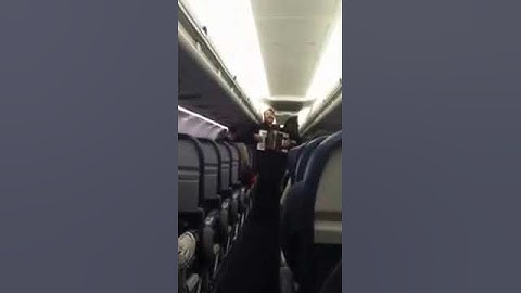 Joey deVilla playing accordion to entertain passengers on his delayed flight