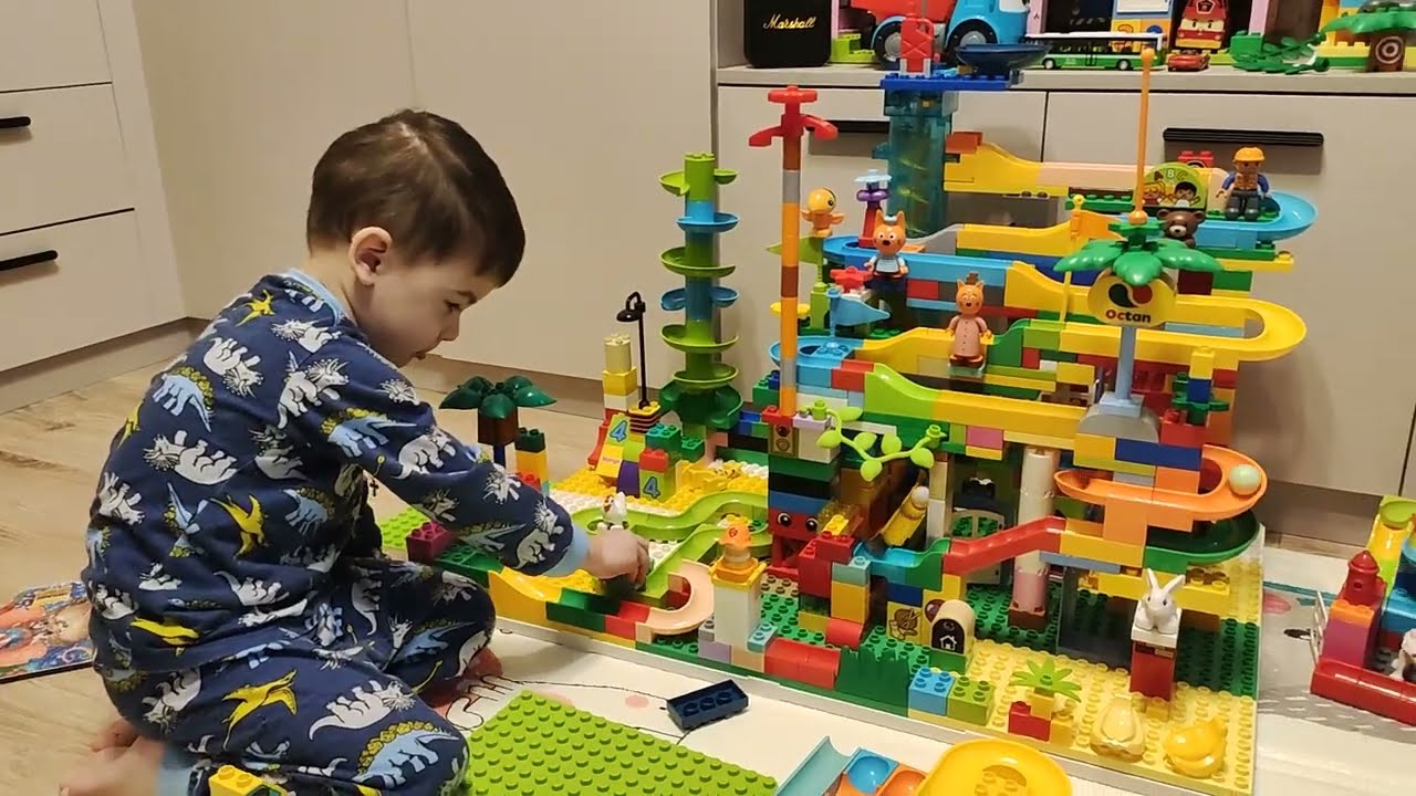 Misha and Lego Duplo. Balls roll along the paths. December 2023