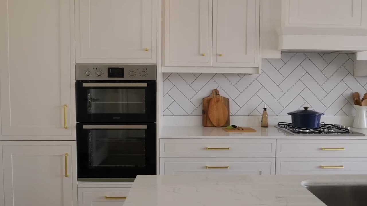A stunning example of our Hampton Cotton White Kitchen and Dust Grey Island, with a Canova Worktop.