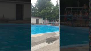 Boy attempts backflip from diving board into pool but hits face on diving board