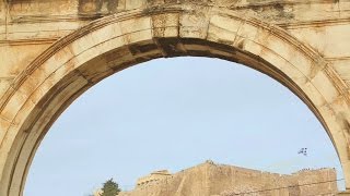 Greek National Flag Waving Over Acropolis Of Athens Seen Through Hadrians Gate. Stock Footage