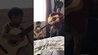 Dad and son playing guitar