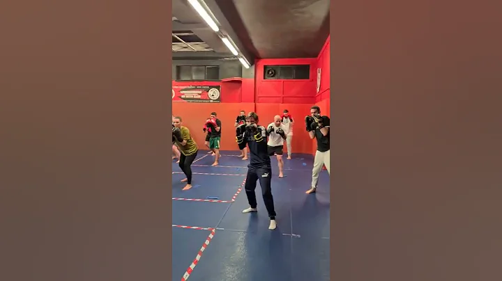 Boxing class going through defensive drills.