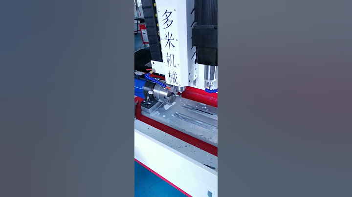 Engineers are debugging a four axis drilling machine to drill tap stainless steel bolts M3 threads