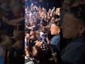Billie Eilish is getting the biggest group hug ever in London! Can you see her?