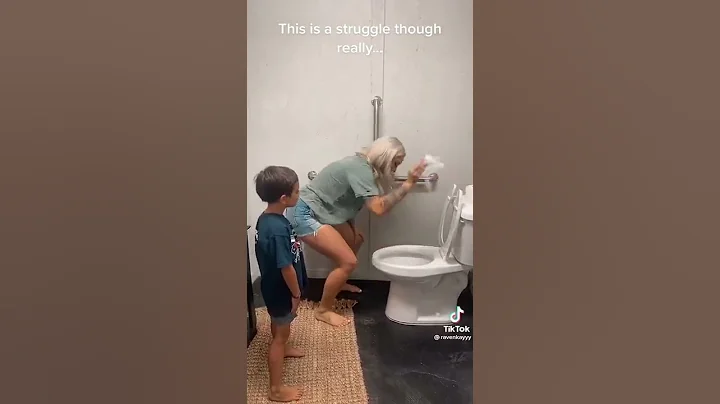 A mother teaching a son how to use the restroom