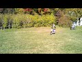 Mckenna and zach driving dirt bikes in the backyard