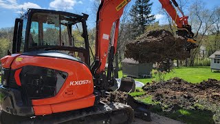 KX0575 with Engcon tearing out a large tree stump