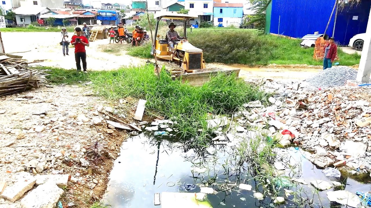 Completed Project Pushing Rock to the dirty water , garbage and some of grass by Bulldozer and Truck