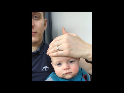 Dad Puts Baby to Sleep by Sliding Hand on Face - 1021454