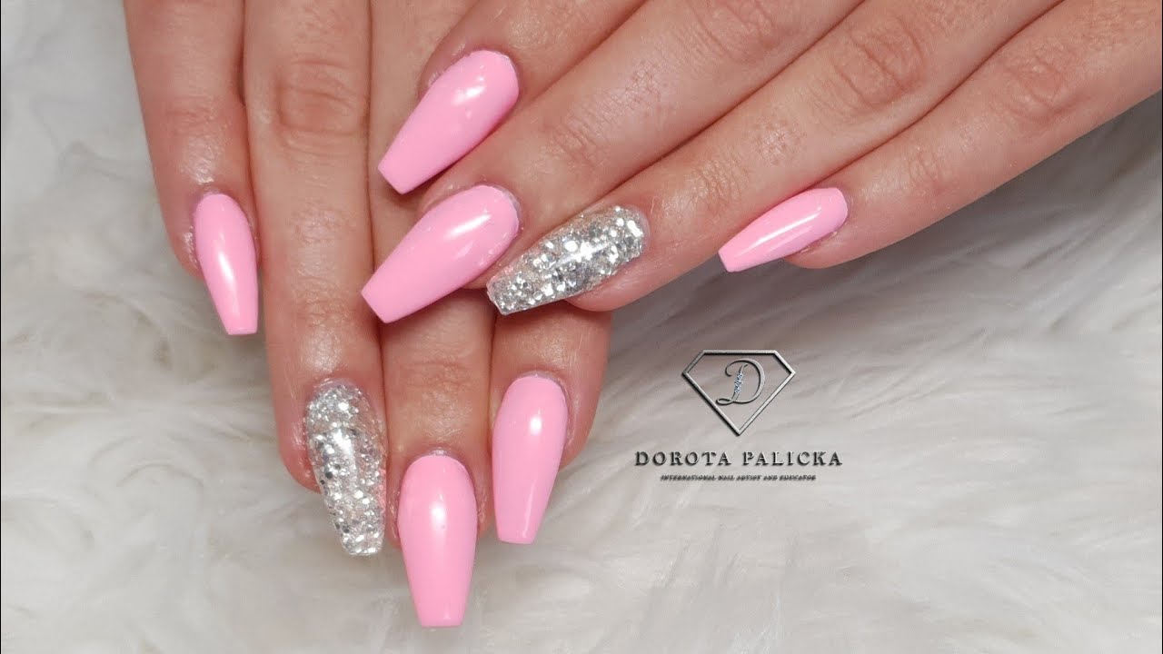 Salon nails. Fiber gel rebalance on lifting nails with pink gel polish and glitter encapsulation