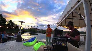 Slow deep house and saxophonist with DJ on sunset background