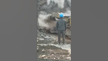 Roadheader begins cutting into the rock face, sparks and dust rising #tunnelboringmachine