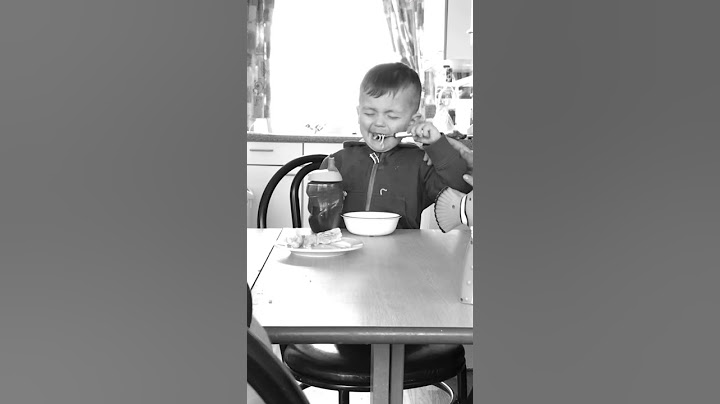 Hungry child trying to eat whilst falling asleep and crying because he cant fit fork in his mouth