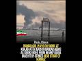 Iranian Girl Swings at Beach as Smoke Rises from Hit Naval Base Near Hormuz