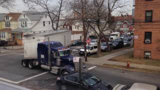 truck making tight turn on residental street