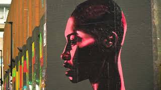 [FREE STOCK VIDEO] Street Art Graffiti Of An African Caribbean Jamaican Woman With Short Hair Red