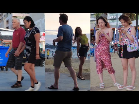 Pattaya beach: Caucasian man and his Thai girlfriend, old Caucasian man walking with his Thai wife