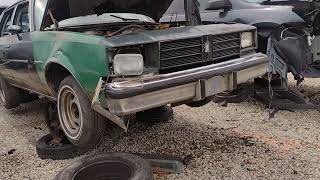 1981 Oldsmobile Cutlass in the Junkyard Rusty gold V8 four door.