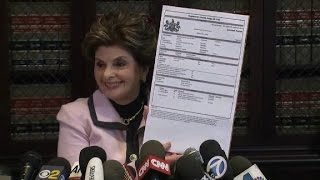 Allred holds up Cosby arrest warrant, says she's happy