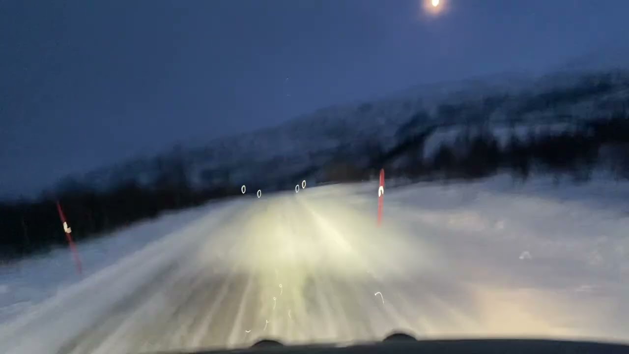Relax drive on snowy roads in Norways Polar Circle along the coast of Barents See. 