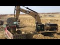 Caterpillar 374D Excavator Loading Trucks