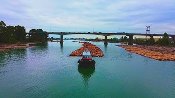 KEN and DOROTHY MACKENZIE towing a log tow up the Fraser River.