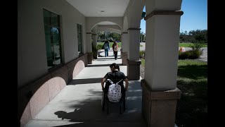 Occupational therapy students at FGCU navigate campus in wheelchairs for class assignment