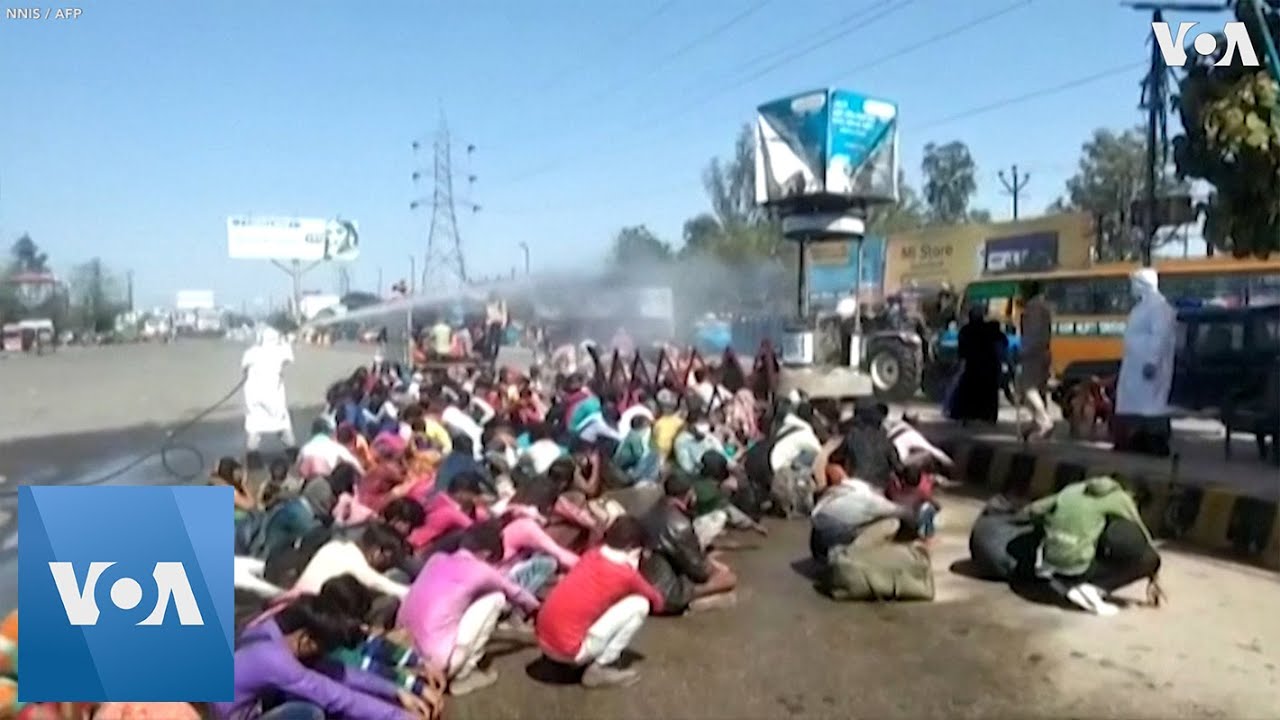 India Migrants Hosed Down with Disinfectant
