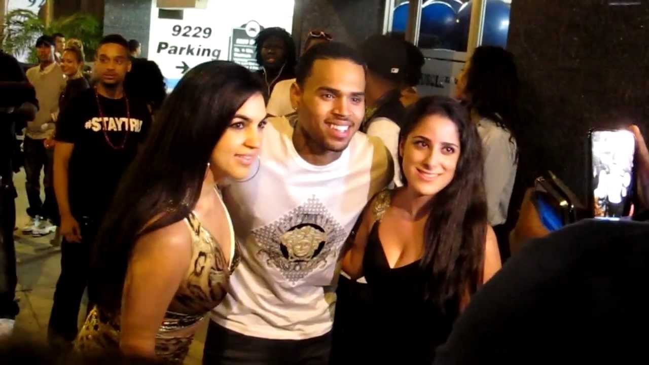 Chris Brown greets fan while arriving at Bootsy Bellows in