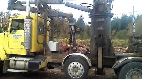 Loading log  trailer  onto self loader