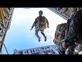 Us marines paratroopers jump from kc130 hercules and uh1n huey