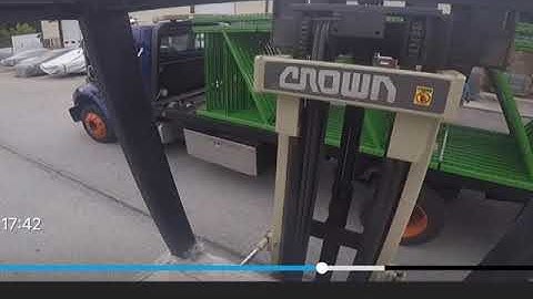 Forklift unloading pallet racks. These are 14’ long uprights. Standing Crown forklift