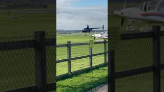 Robinson R44 Raven II hovering Tecnam P2002JF Cotswolds airport
