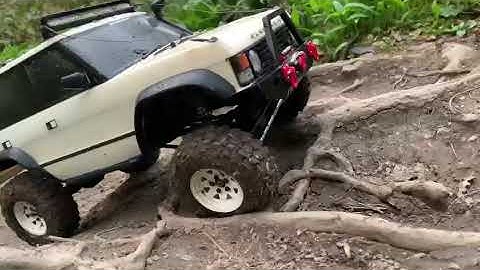 Carisma RC Scale Range Rover climbing roots on the trail