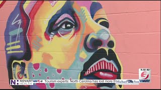 Local artist paints on Princess Street with Dr. Martin Luther King Jr. mural