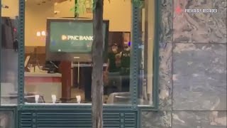 Alleged armed robber holds people hostage at Loop bank