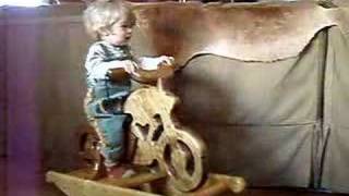 Rocking Horse 2 of 2 Saul mounts and rides his rocking horse (motorcycle)