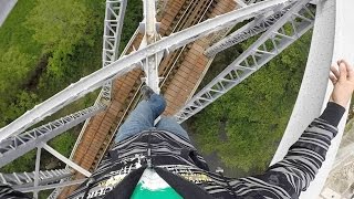 Man Walks On Bridge Poles Above Moving Train