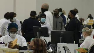 Election workers in Detroit counting absentee ballots at TCF Center