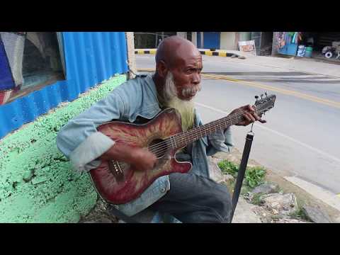 Street Music in Maubisse Timor Leste Timorese playing Country Music on Guitar