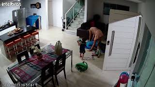Mom gives Dad massage on living room floor then boy throws toy at brother (Security camera)
