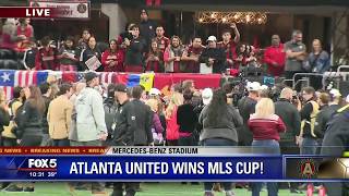 Arthur Blanks raises the Alan I  Rothenberg Trophy following Atlanta United's MLS Cup victory